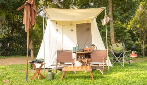 A white teepee tent with glamping interiorwith desk and chairs at the campsite in forest,holiday,vacation,Camping